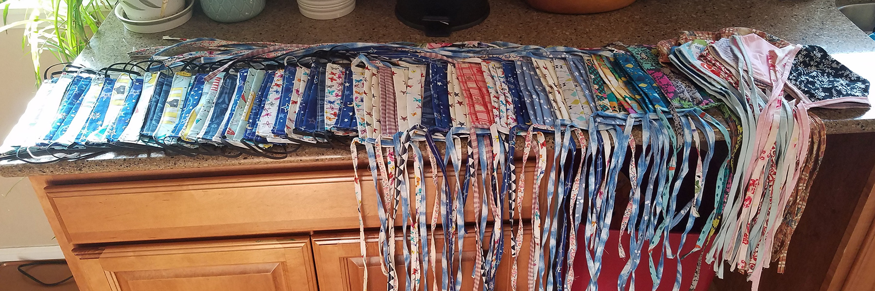 cloth facemasks sit on a kitchen counter