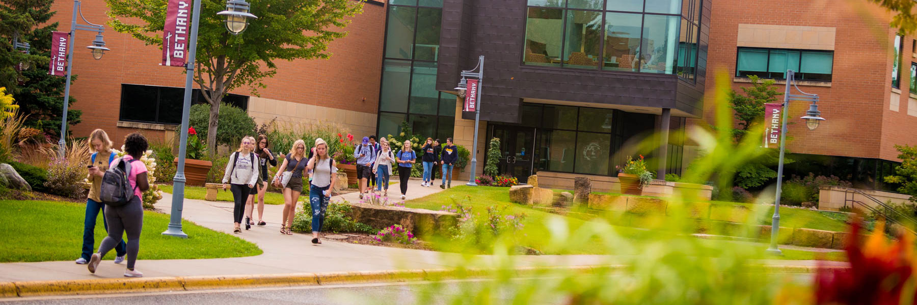 students walk across campus outside of Honsey Hall