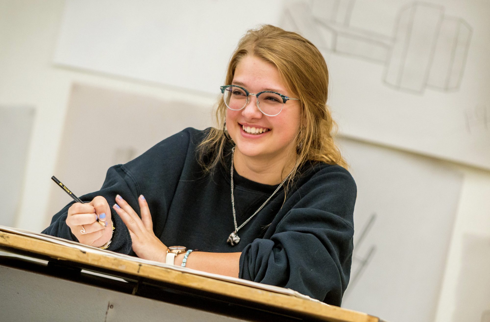 female student smiling in art class