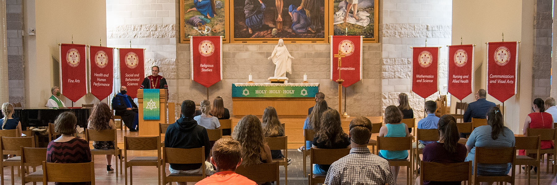 President Gene Pfeifer talks to students and staff in Trinity Chapel