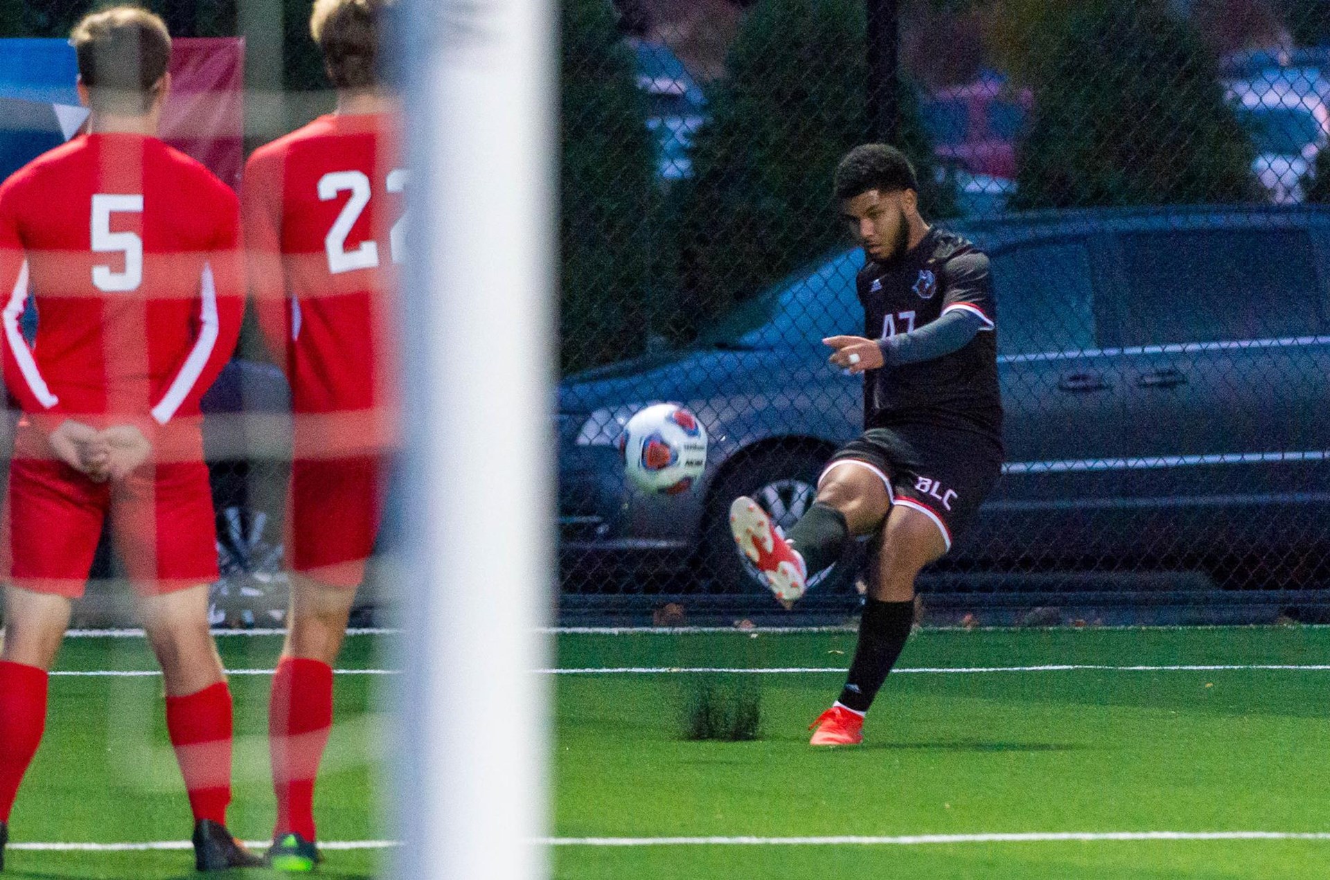 Bethany Lutheran men's soccer player (#47) kicks ball - 2020