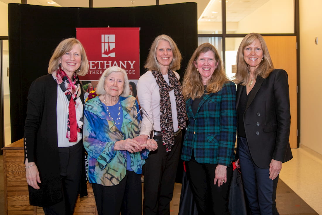 5 women posing with the Distinguished Alumni Award (family members of recipient)