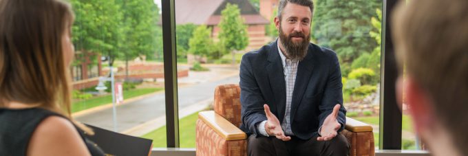 Counselor (Ben Kohls) talking to two people