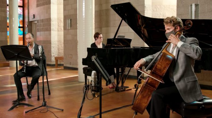 Photo of classical trio in Trinity Chapel (oboe, piano, and cello players)