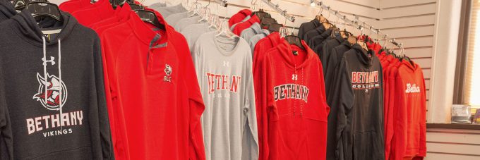 Sweatshirts of various styles hanging in the Spirit Shop