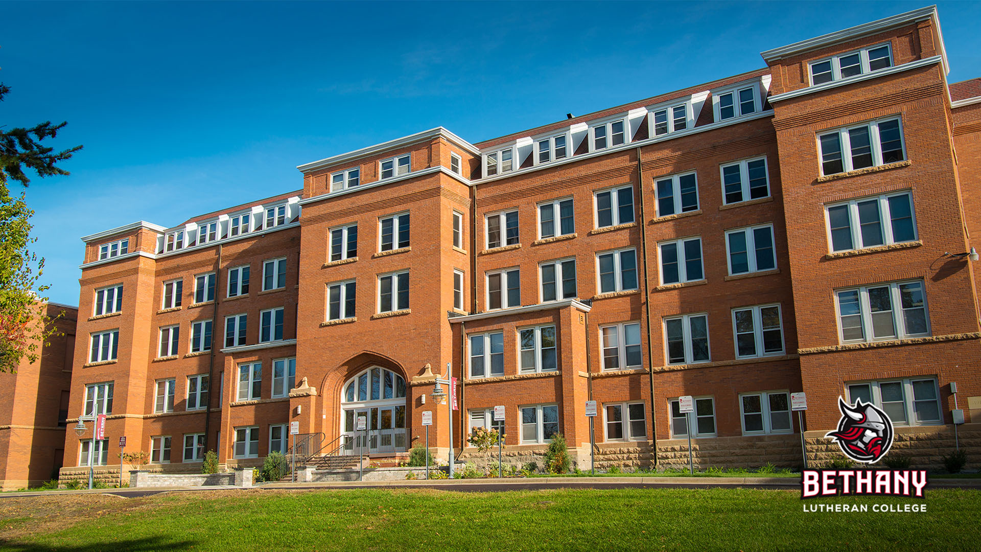 old main, with a logo in the lower right corner