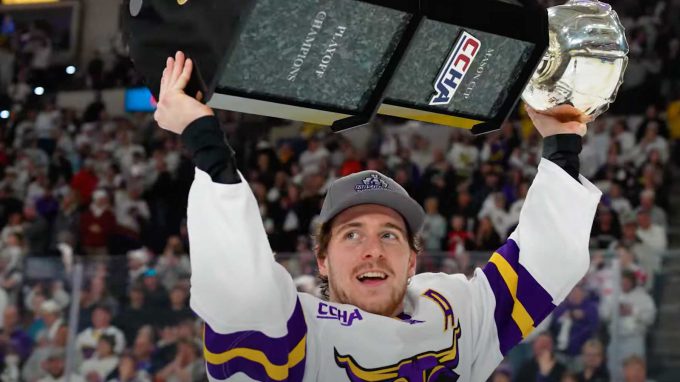 hockey player raising trophy over his head