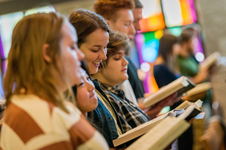 Students singing in chapel