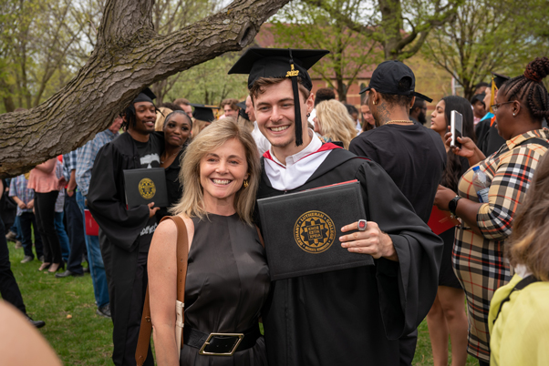 Graduate posing with family member