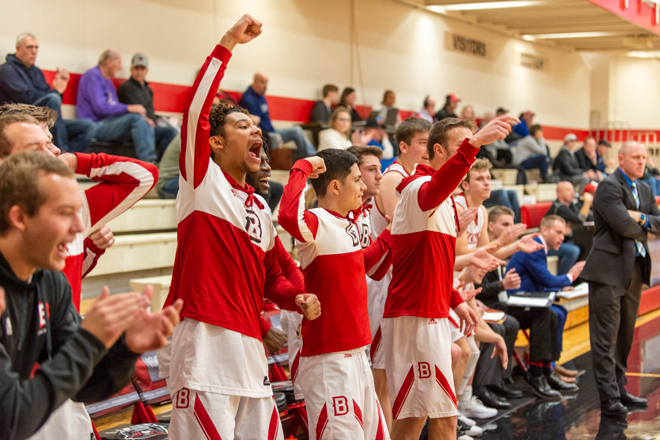 Men's basketball players cheering