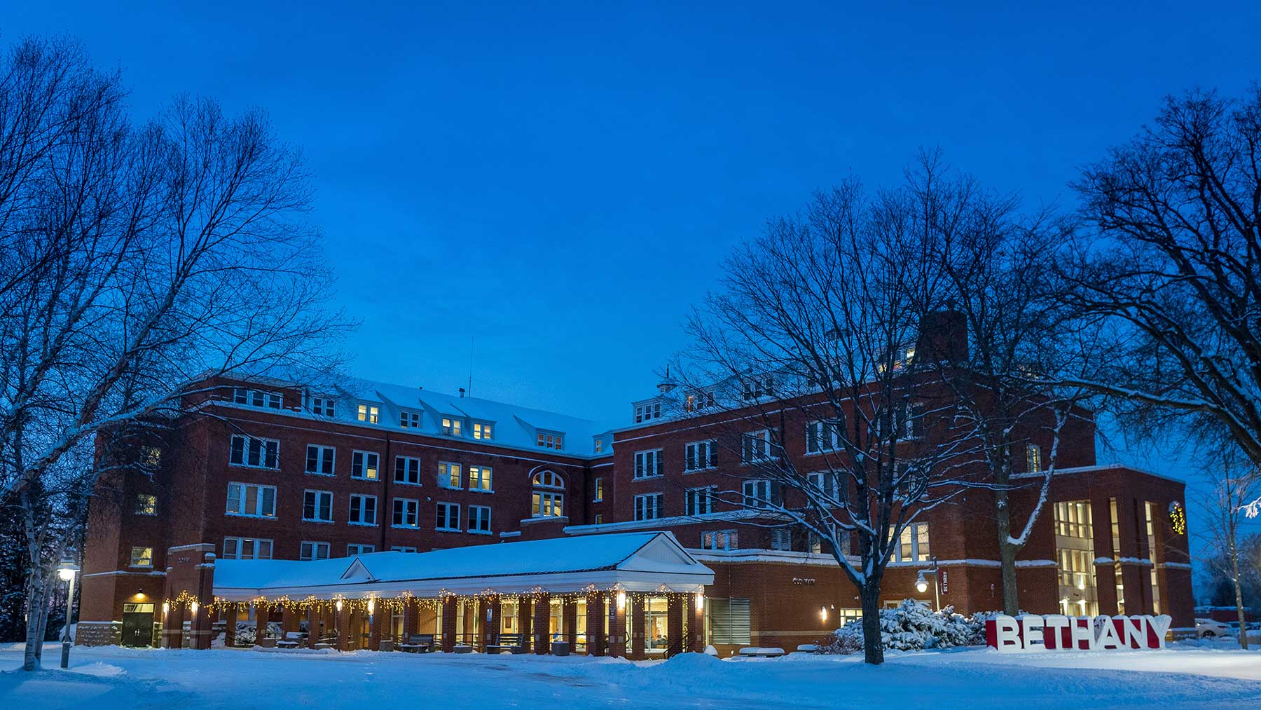 Old Main building at night with Christmas lights