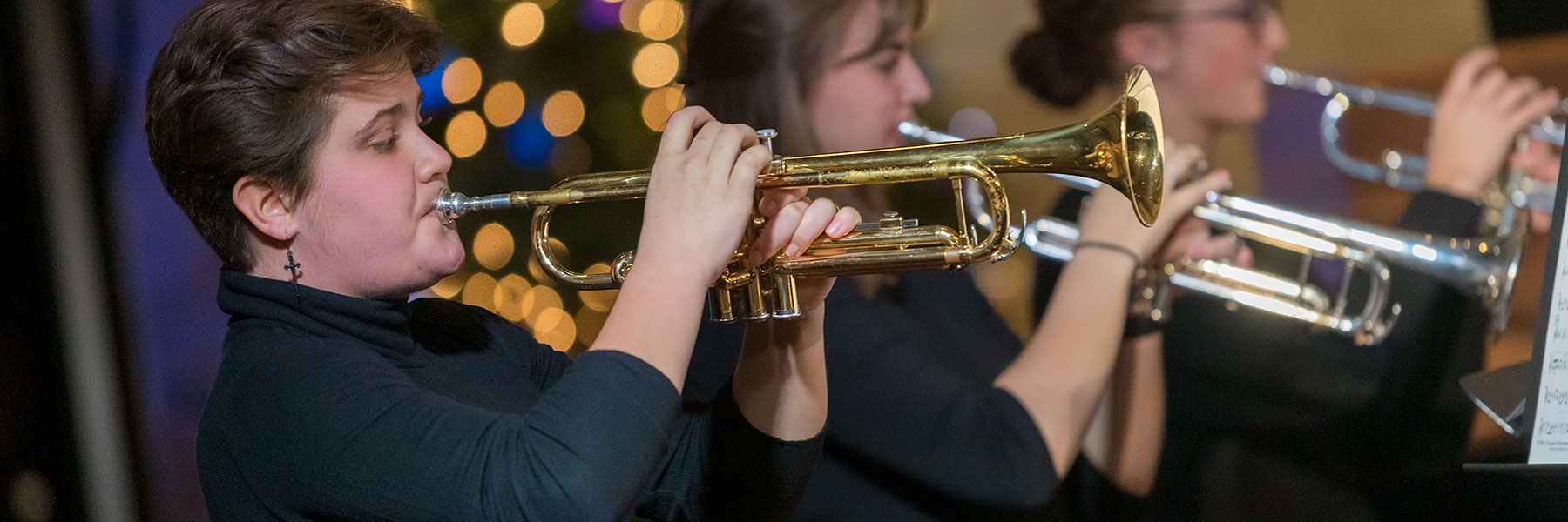 Woman playing trumpet during concert