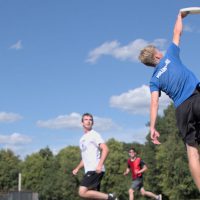 student catching frisbee disc