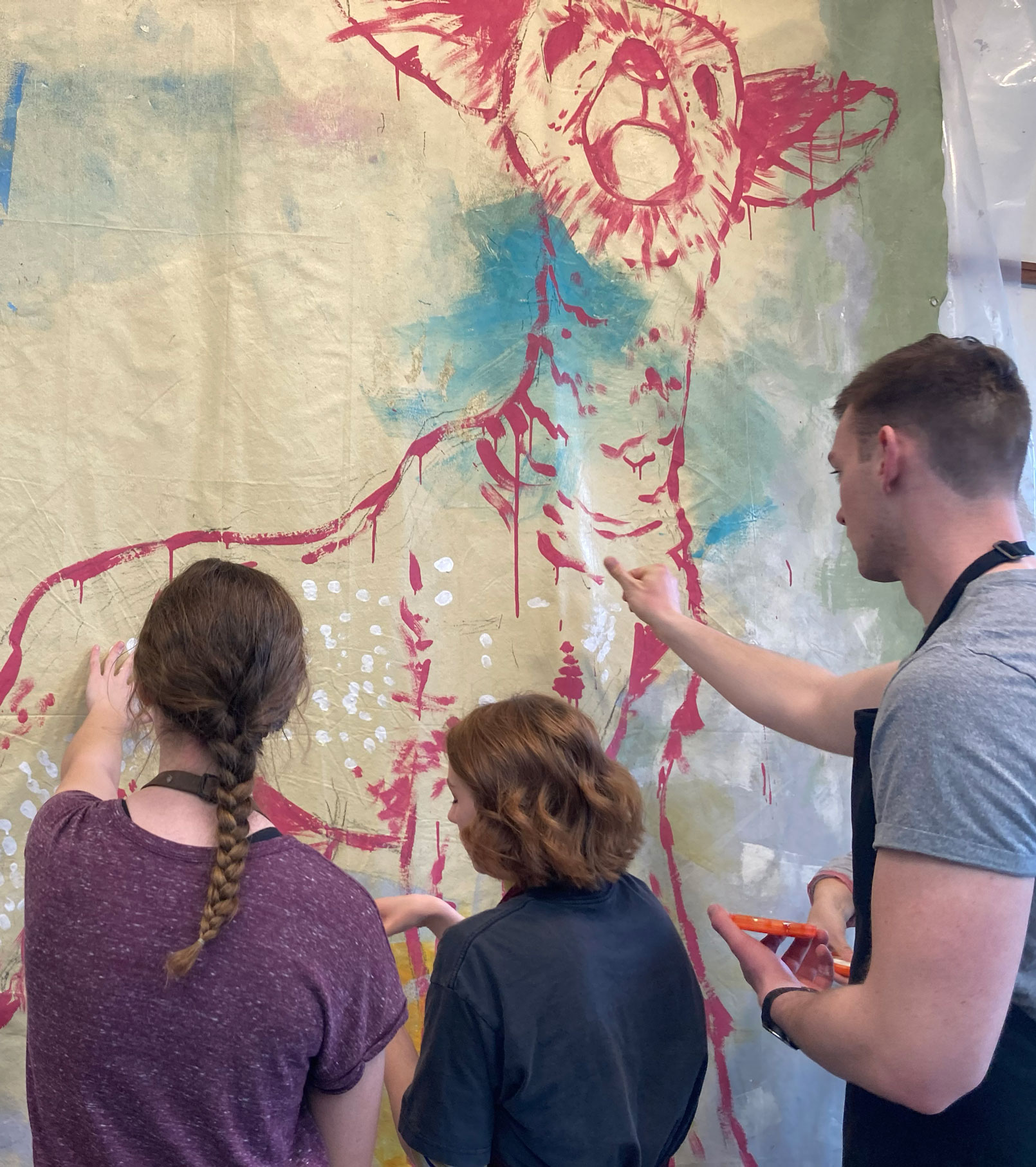 Students working on a painting of a lamb