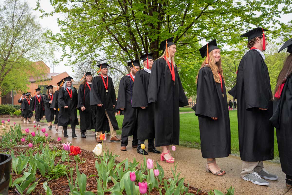 graduates in gowns outside during spring commencement, may 2023