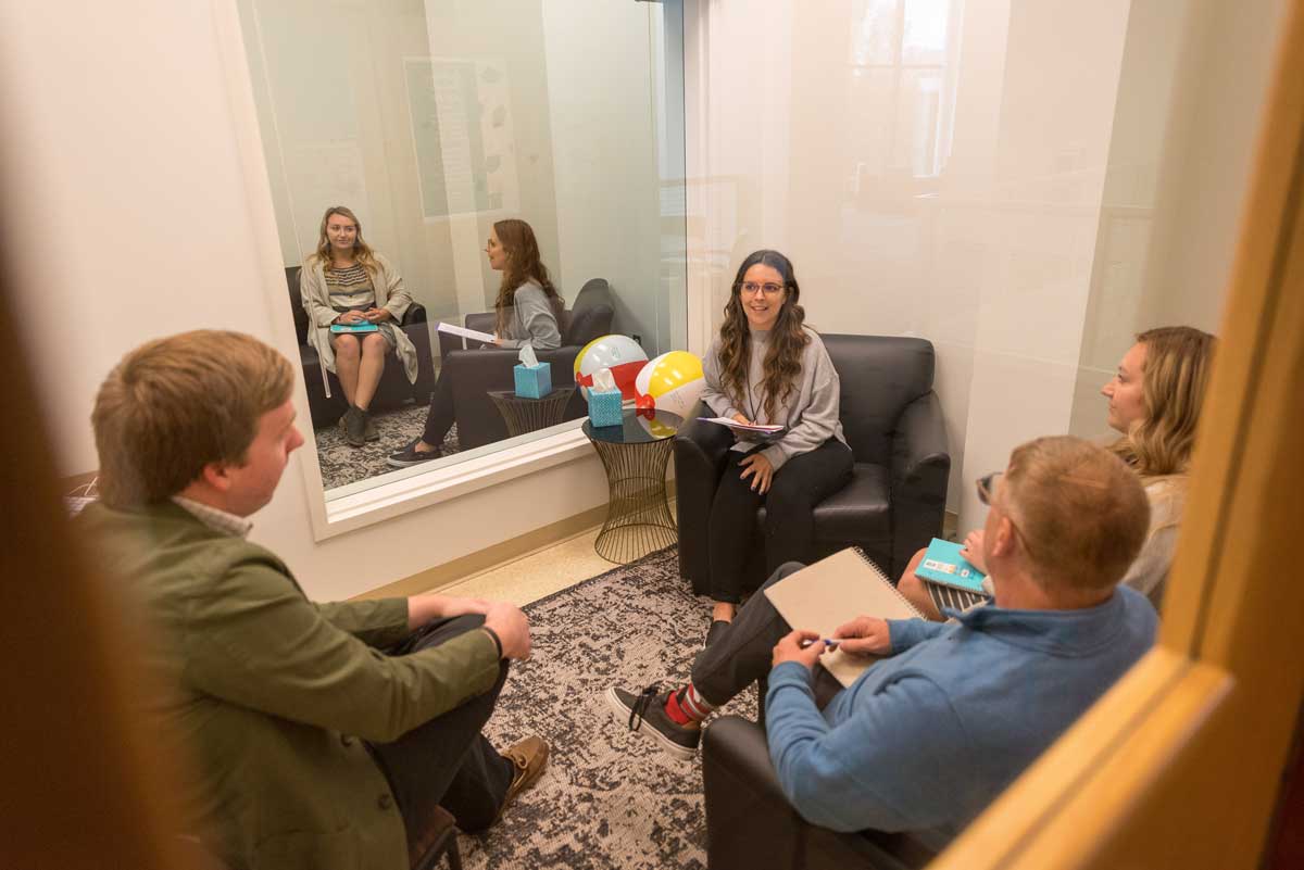 Students in a space, Honsey Hall, practicing skills during their on-campus residency visit, talking together, Bethany Magazine