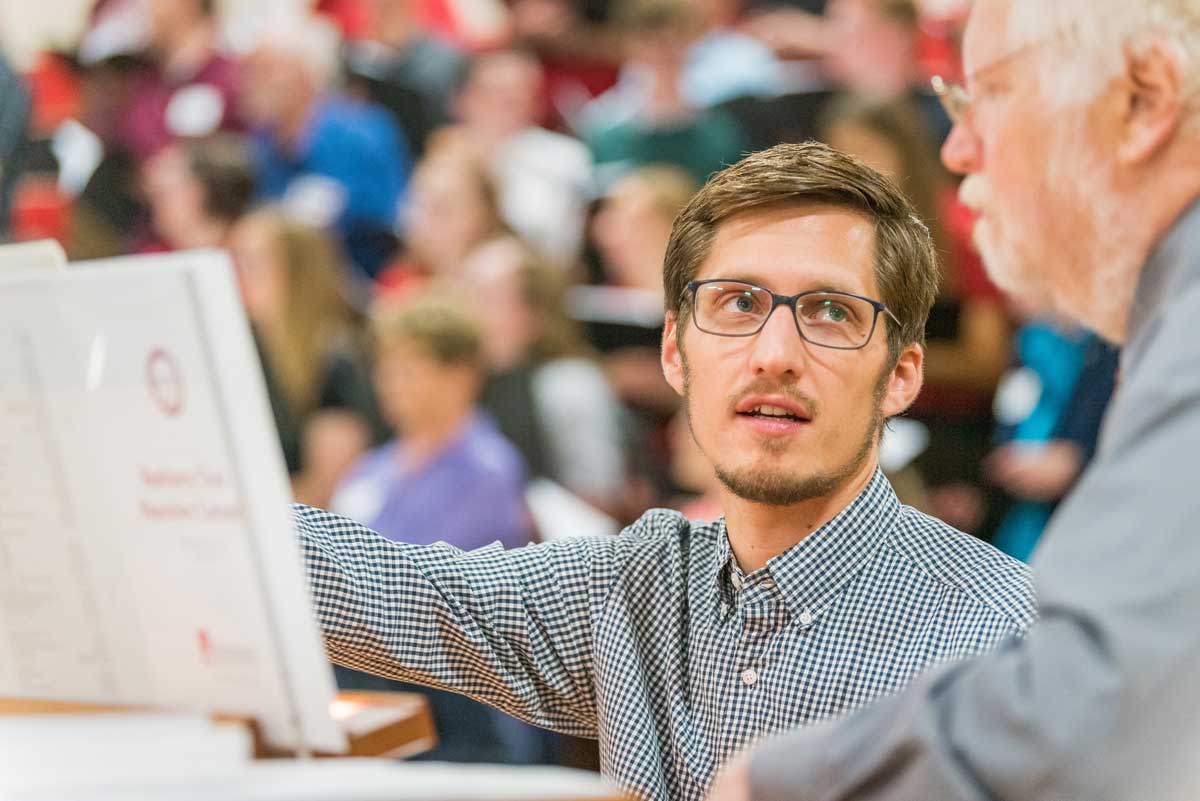 Boy, Jacob Weber, with Professor Mark DeGarmeaux at concert rehearsal, Bethany Magazine