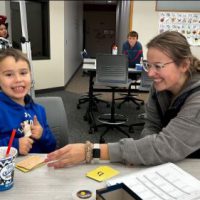 Depicts a reading intervention session in the Bethany Literacy Clinic.