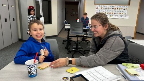 Depicts a reading intervention session in the Bethany Literacy Clinic.